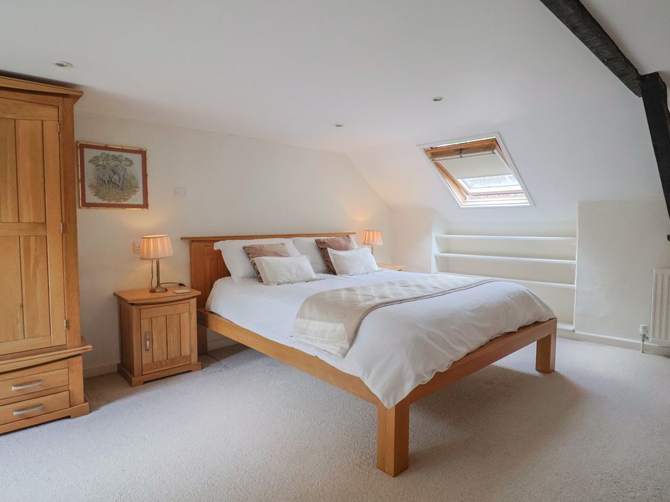 A bedroom with a bed and bedside tables at Ellishayes Farm in Combe Raleigh