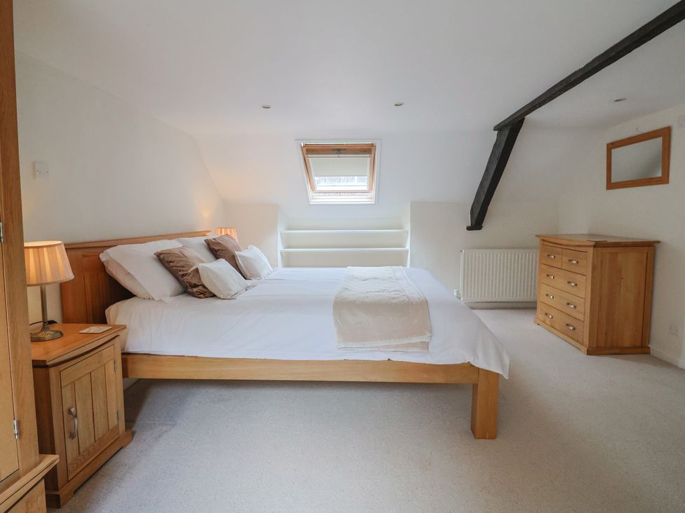 A bedroom with a bed and bedside furniture at Ellishayes Farm in Combe Raleigh