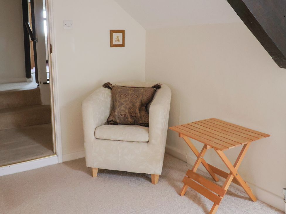 A chair and a side table in a living room at Ellishayes Farm Combe Raleigh