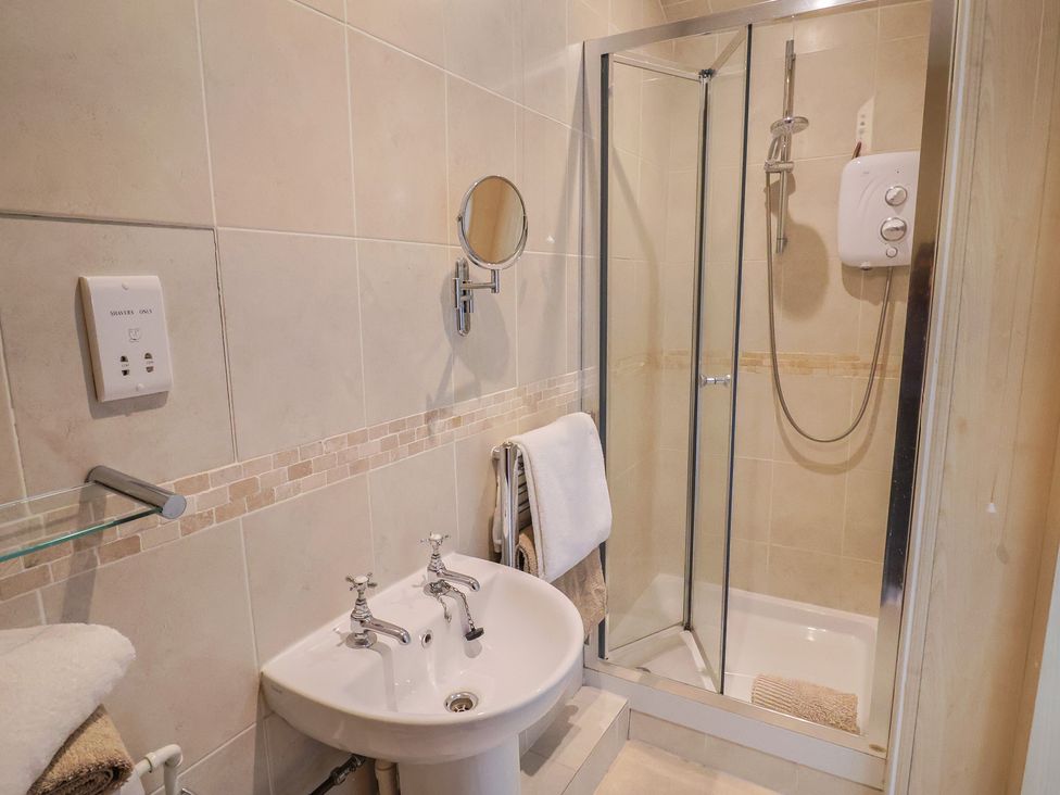 A bathroom featuring a shower and a washbasin at Ellishayes Farm Combe Raleigh