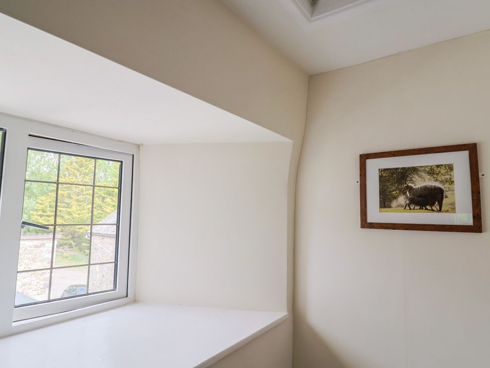 A room with a window and a picture frame at Ellishayes Farm in Combe Raleigh