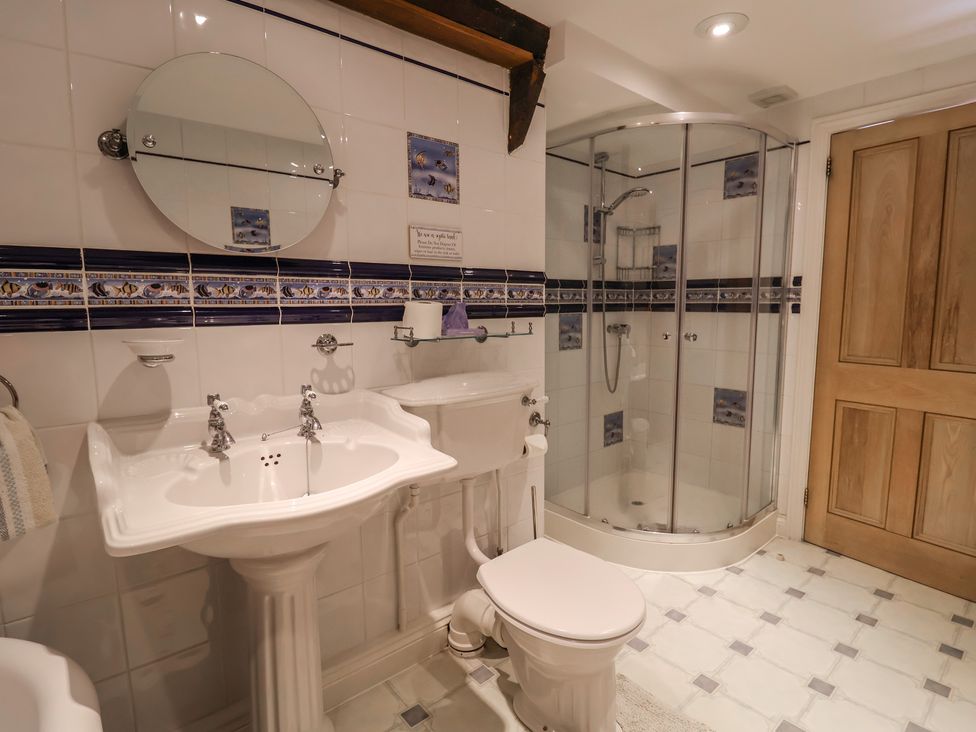 A bathroom with a sink, toilet, and shower at Ellishayes Farm in Combe Raleigh
