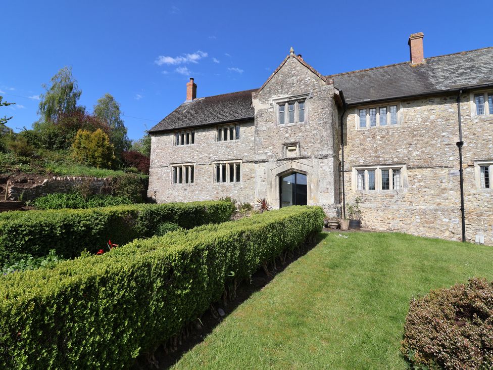 A stone building with a garden at Ellishayes Farm Combe Raleigh