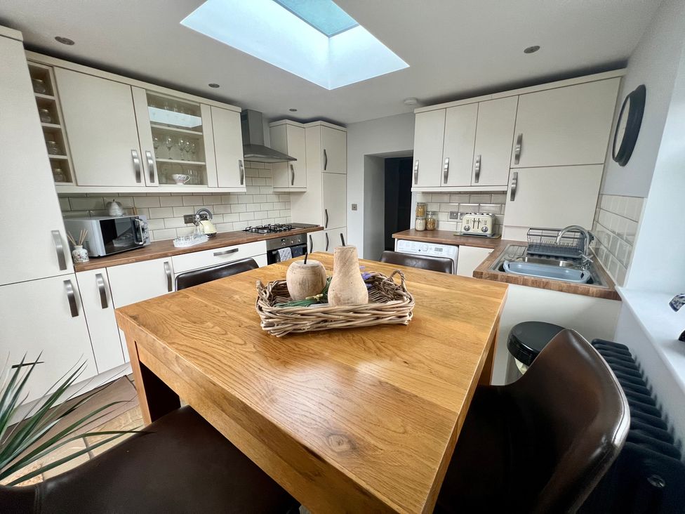 A kitchen with a table and chairs at Penderyn Cottage Aberdare