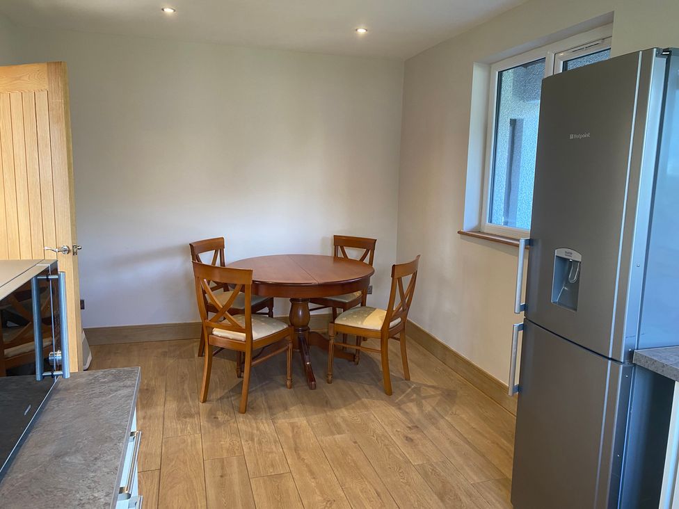 A kitchen with a table and chairs at The Annex at Meeks Park in Alloa