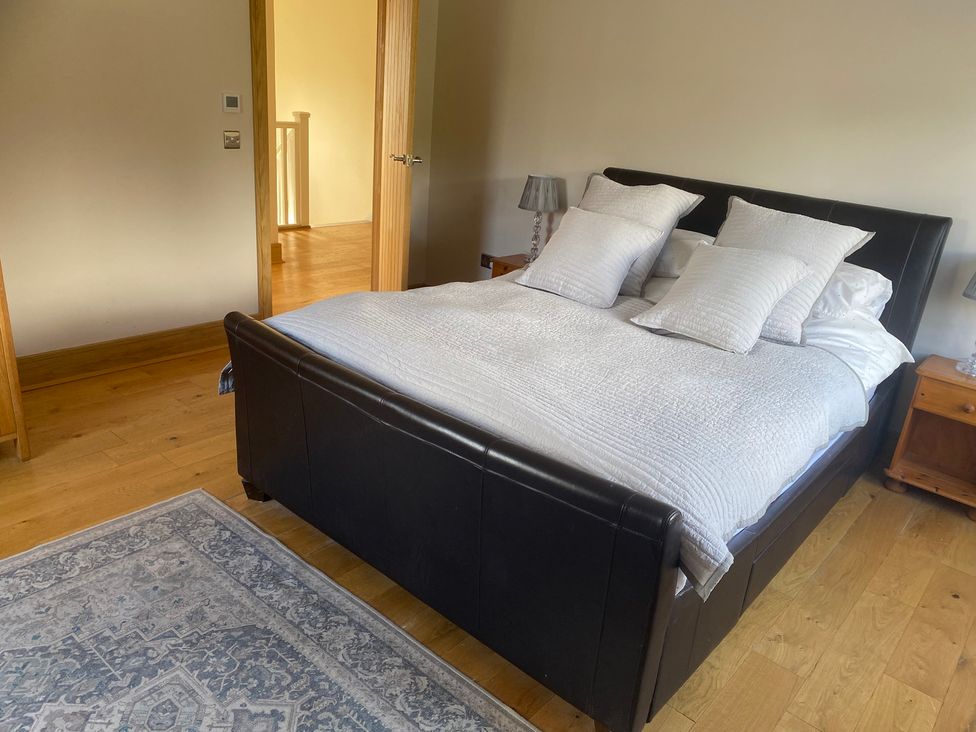 A bedroom with a bed and bedside table at The Annex at Meeks Park Alloa
