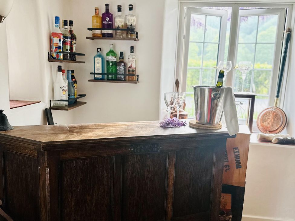A bar with bottles and glasses at The Bark House in Tiverton