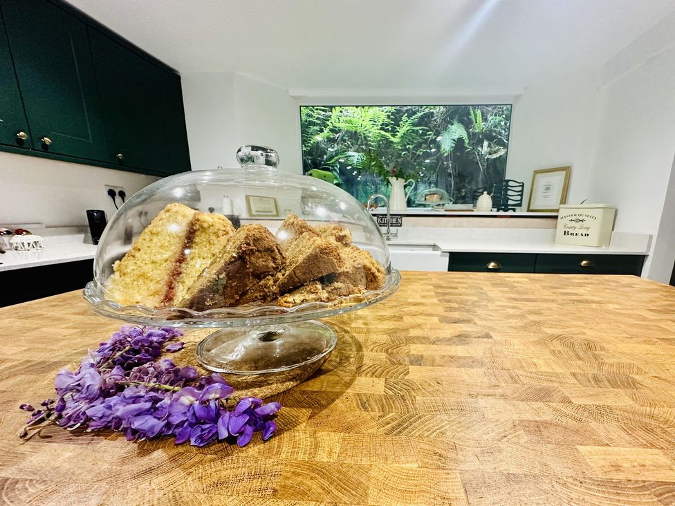 A cake stand with cakes on a kitchen counter at The Bark House in Tiverton