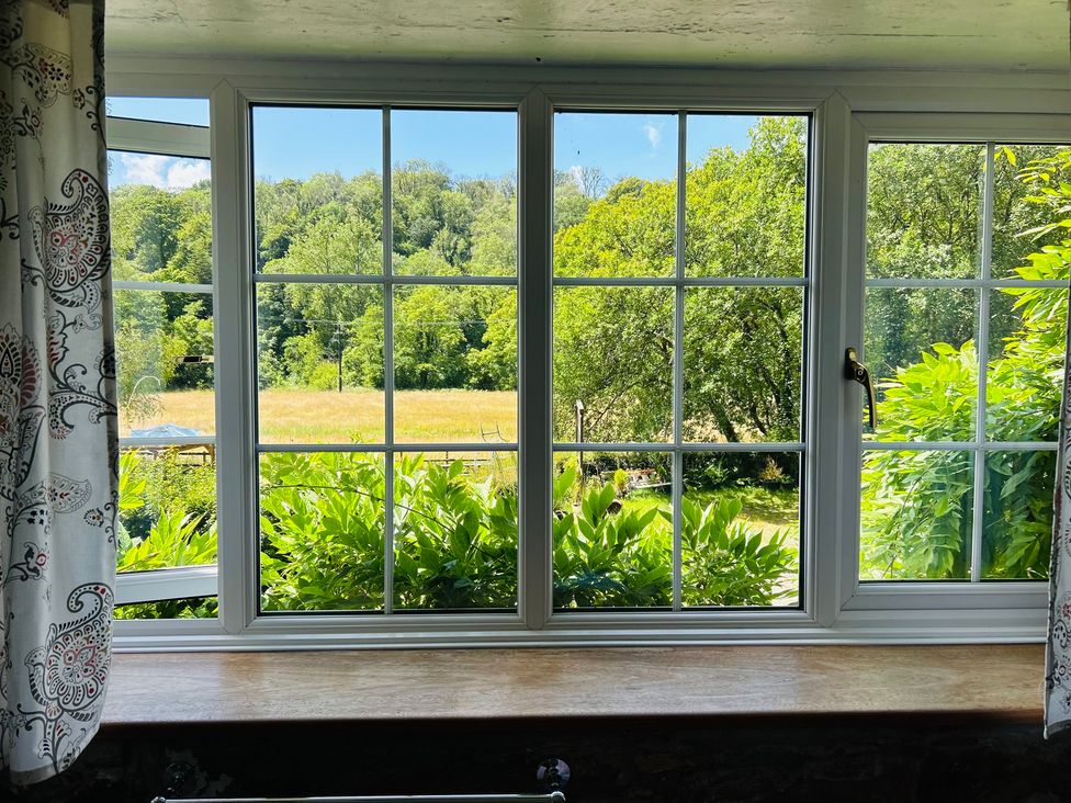 A window with a view of greenery and fields at The Bark House in Tiverton