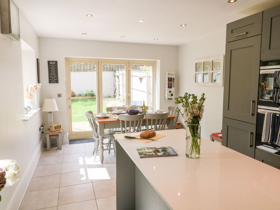 A kitchen with table and chairs in an open layout at East View Cheltenham