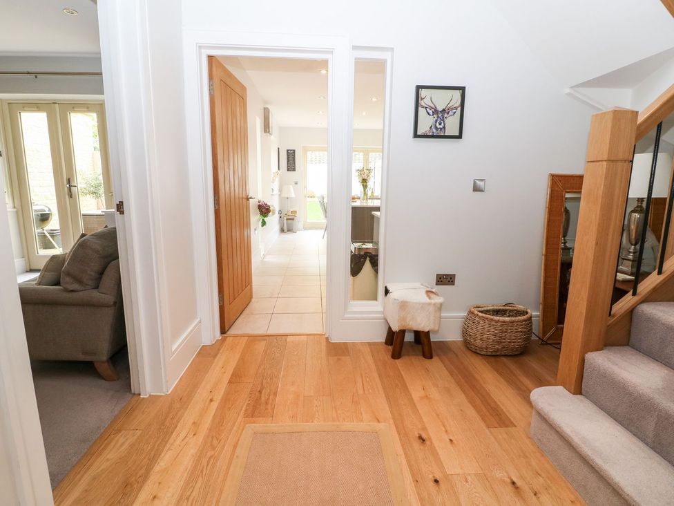 A hallway with stairs and a sofa at East View in Cheltenham