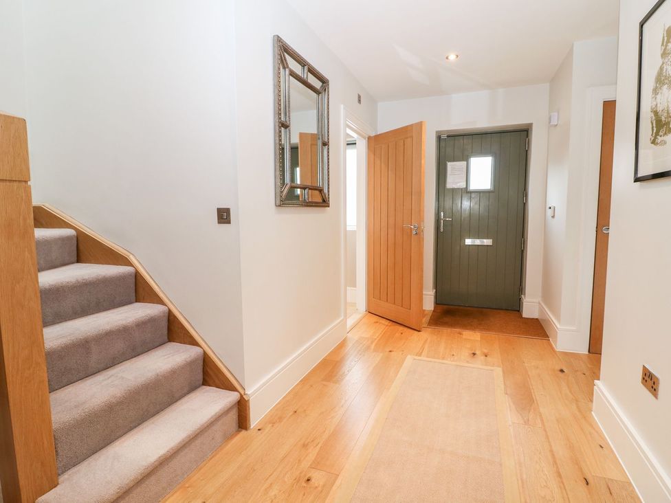 A hallway with stairs and a door at East View in Cheltenham