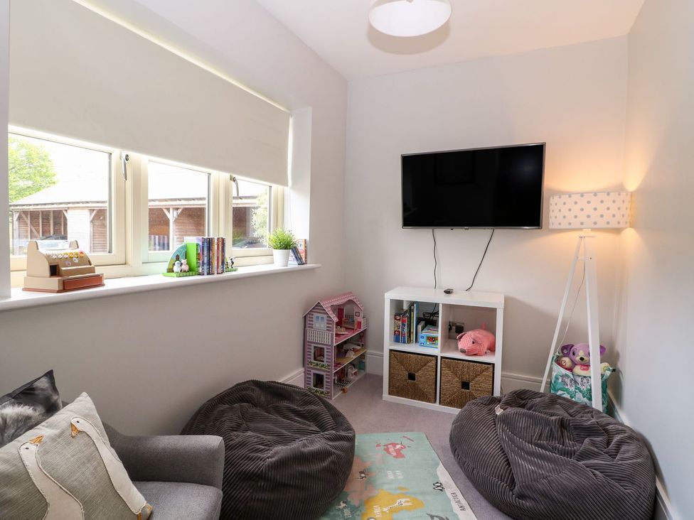 A playroom with bean bags and a television at East View in Cheltenham