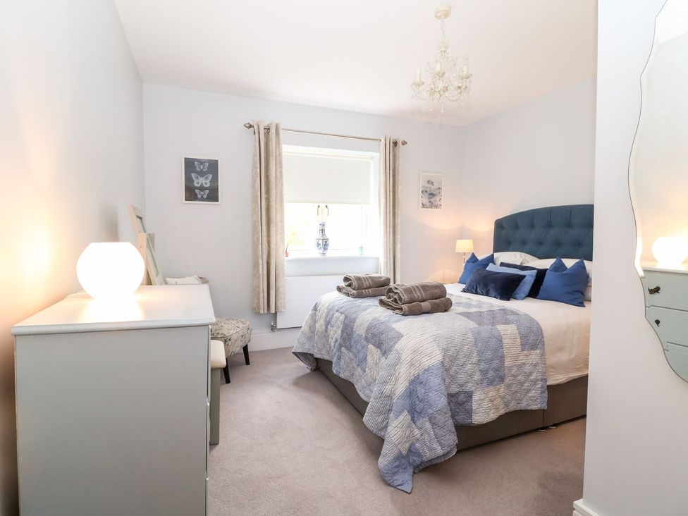 A bedroom with a bed and dresser at East View in Cheltenham