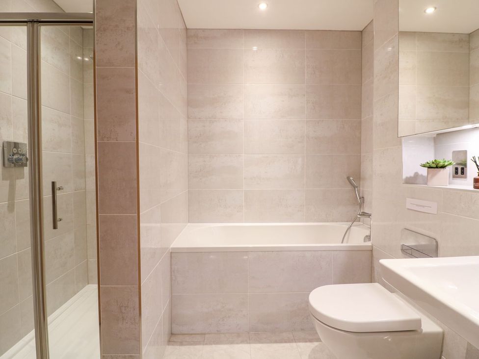 A bathroom with a bathtub and shower at East View in Cheltenham
