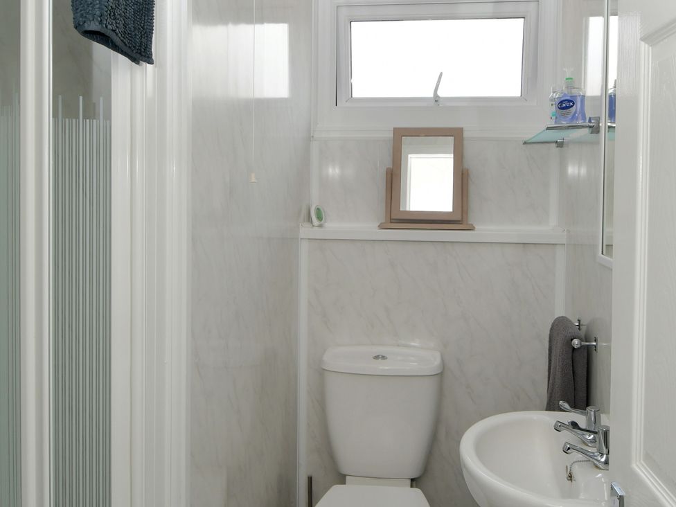 A bathroom with a toilet and sink at 228b Eighth Avenue in Bridlington