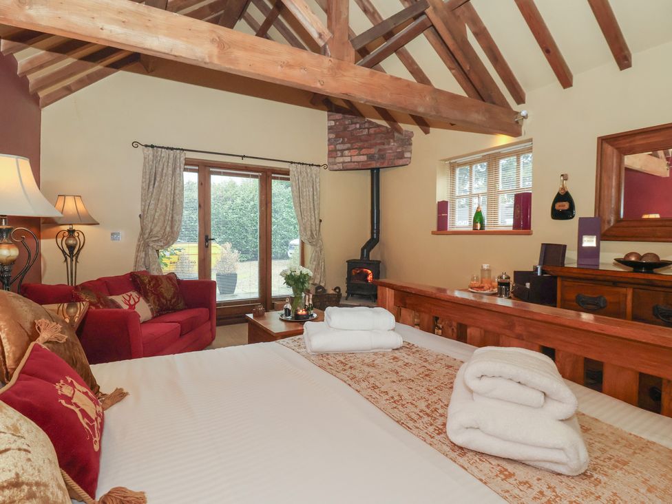 A bedroom with a bed and a fireplace at Champagne Cottage in Malton