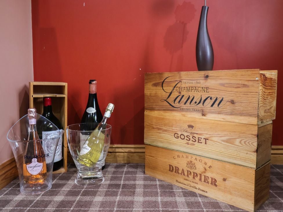 A collection of wine bottles and an ice bucket at Champagne Cottage in Malton