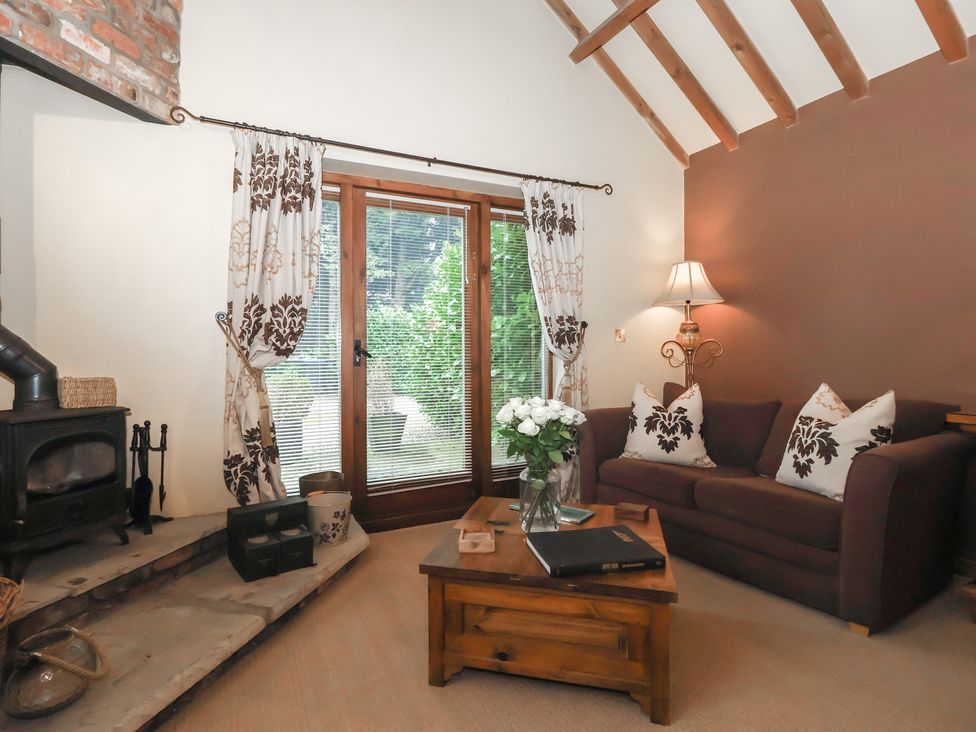 A living room with a sofa and coffee table at Champagne Cottage in Malton