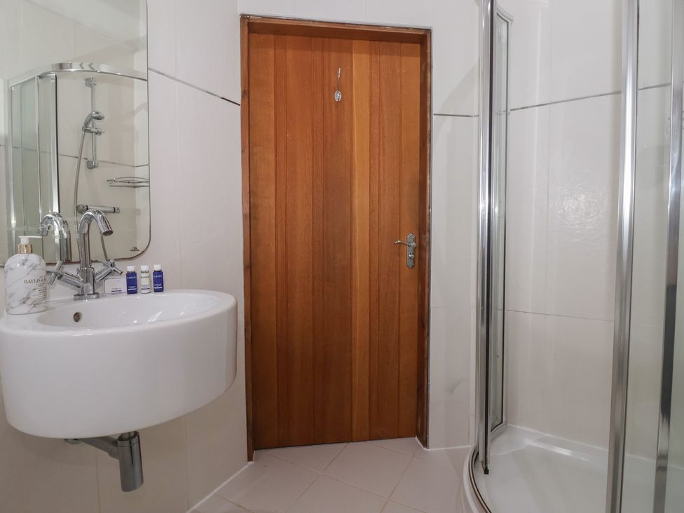 A bathroom with a sink and shower at Champagne Cottage in Malton