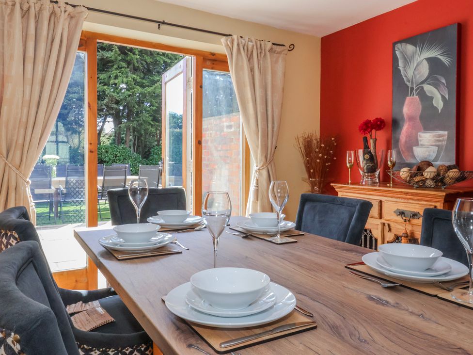 A dining room with a table and chairs at Champagne Cottage in Weaverthorpe
