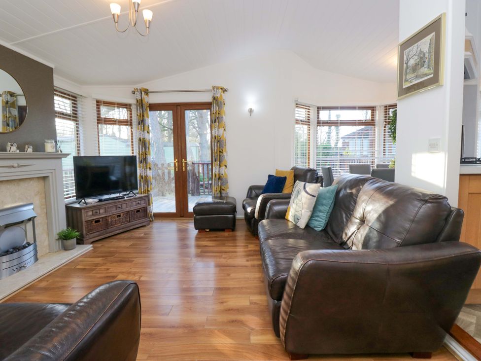 A living room with a television and seating area at 6 Waterside Windermere