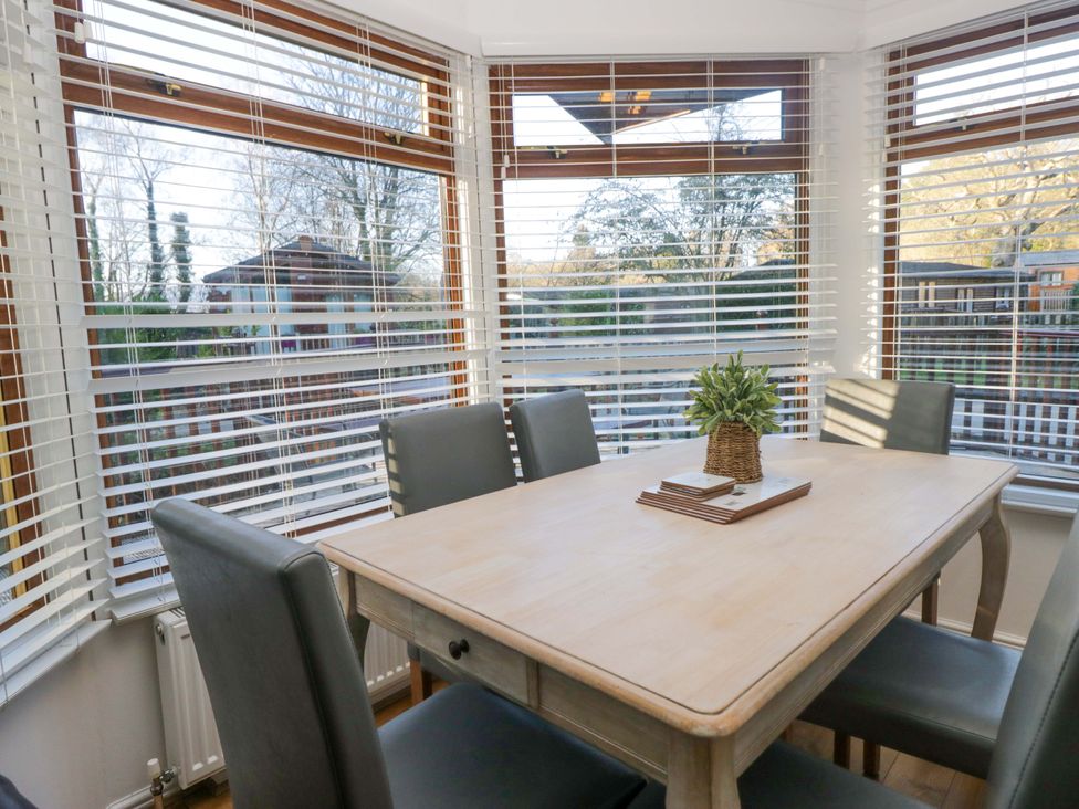A dining room with a table and chairs at 6 Waterside in Windermere