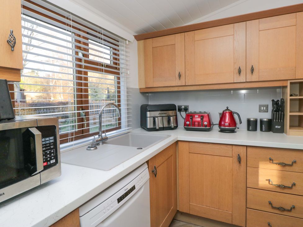 A kitchen with a sink and appliances at 6 Waterside in Windermere