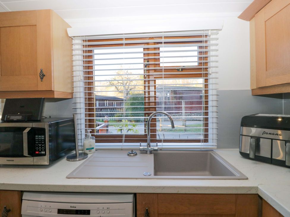 A kitchen with a sink and window at 6 Waterside in Windermere