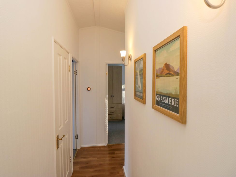 A hallway with doors and wall art at 6 Waterside in Windermere