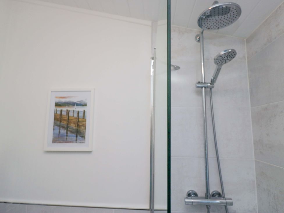 A shower area with a framed picture at 6 Waterside in Windermere