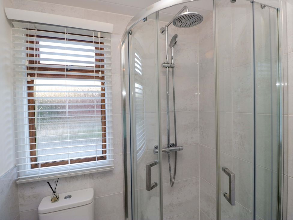 A bathroom with a shower and toilet at 6 Waterside in Windermere