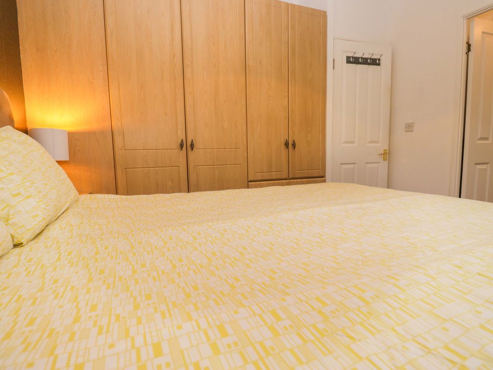 A bedroom with a bed and wardrobe at 6 Waterside, White Cross Bay near Windermere