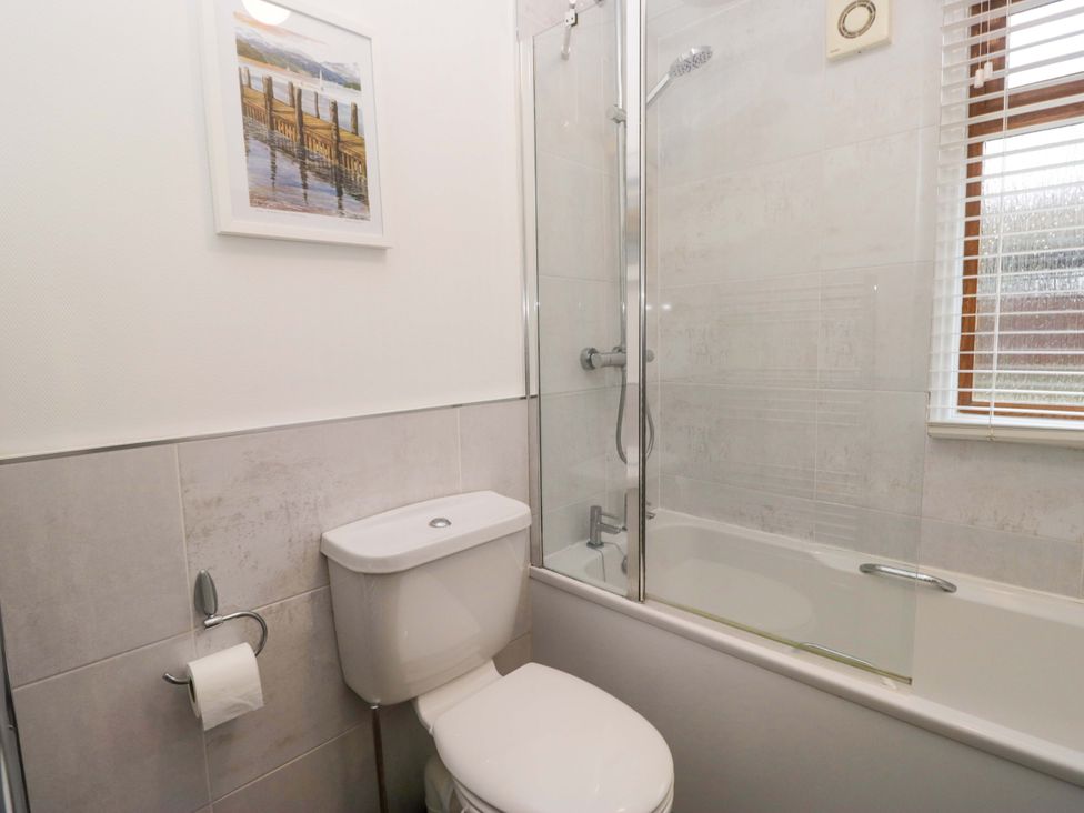 A bathroom with a shower and bathtub at 6 Waterside, White Cross Bay near Windermere