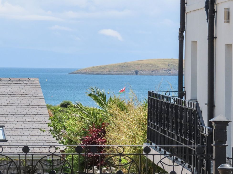 View of ocean and island with a flag at Angorfa Apartment Abersoch