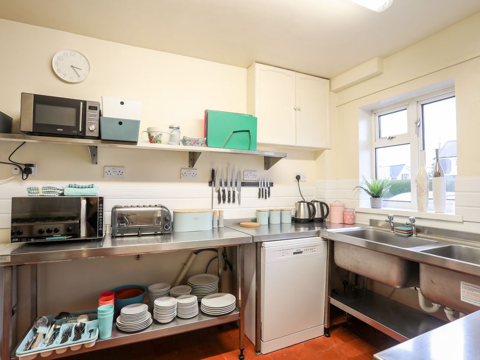 A kitchen with appliances and utensils at Angorfa Apartment in Abersoch