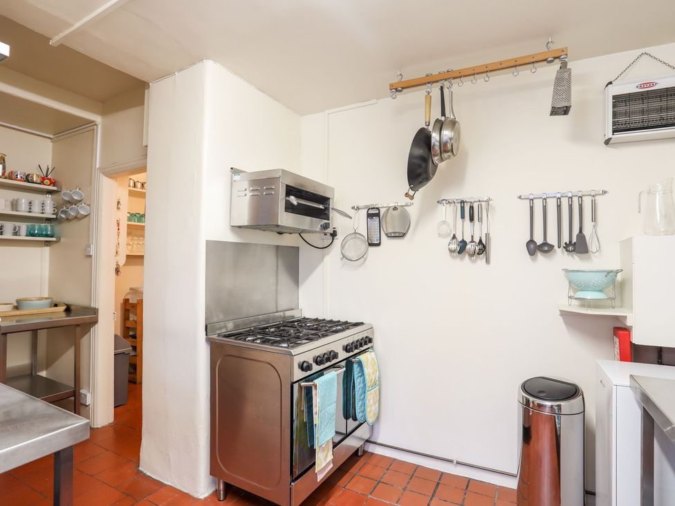 A kitchen with a stove and utensils at Angorfa Apartment in Abersoch