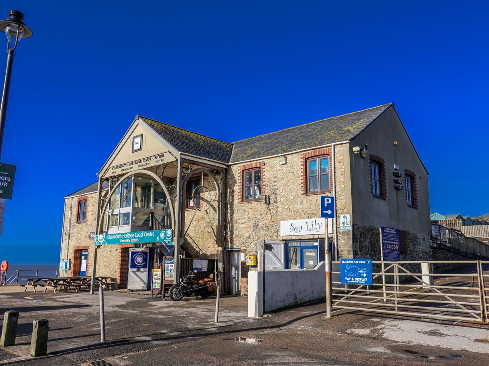 A building with a sign for Charmouth Heritage Coast Centre and Sea Lily in Charmouth
