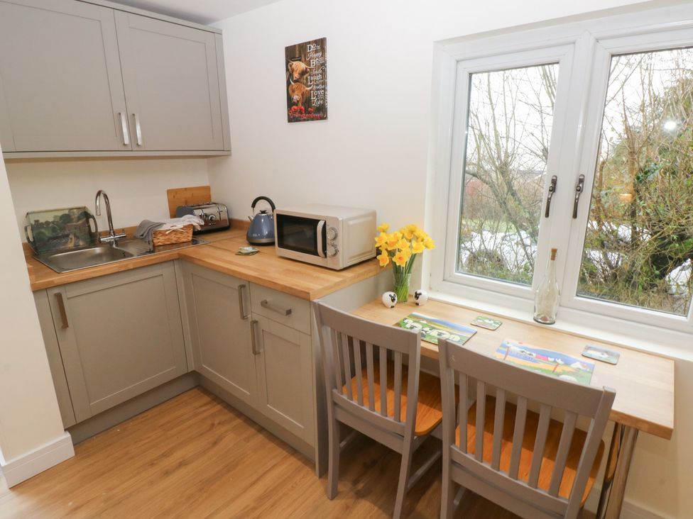 A kitchen with a sink and appliances at Heidiaway Lodge in Porth