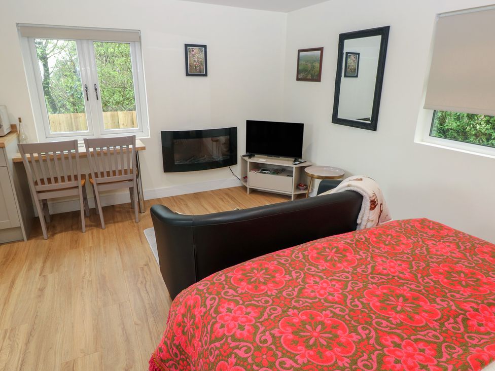 A living room with a bed and furniture at Heidiaway Lodge in Gilfach Goch