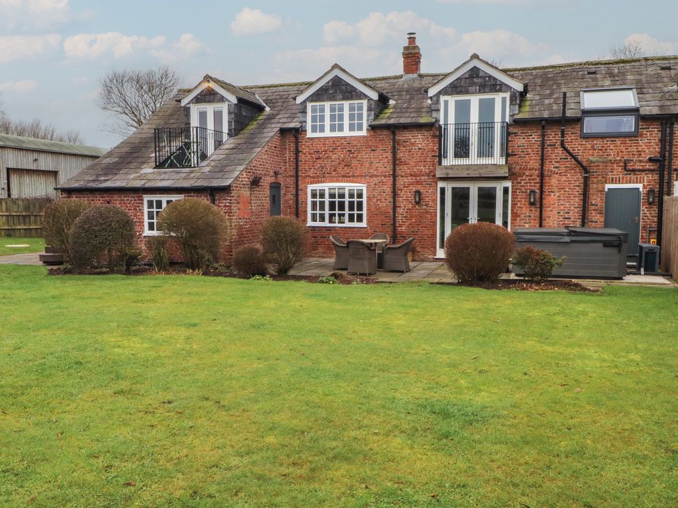 A house with garden and patio furniture at The Winnows in Knutsford