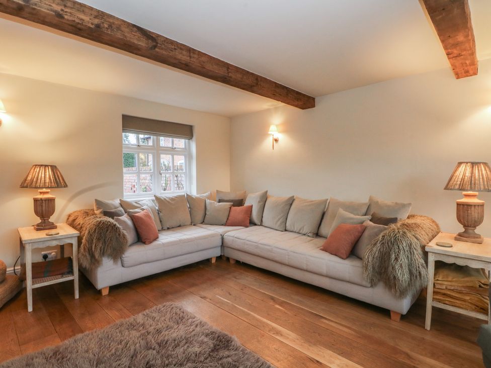 A living room with a sofa and table at The Winnows in Knutsford