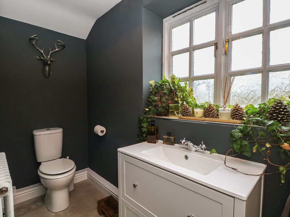 A bathroom with a toilet and sink at The Winnows in Knutsford