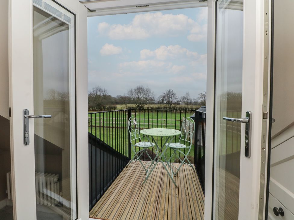 A balcony with a table and chairs at The Winnows in Knutsford