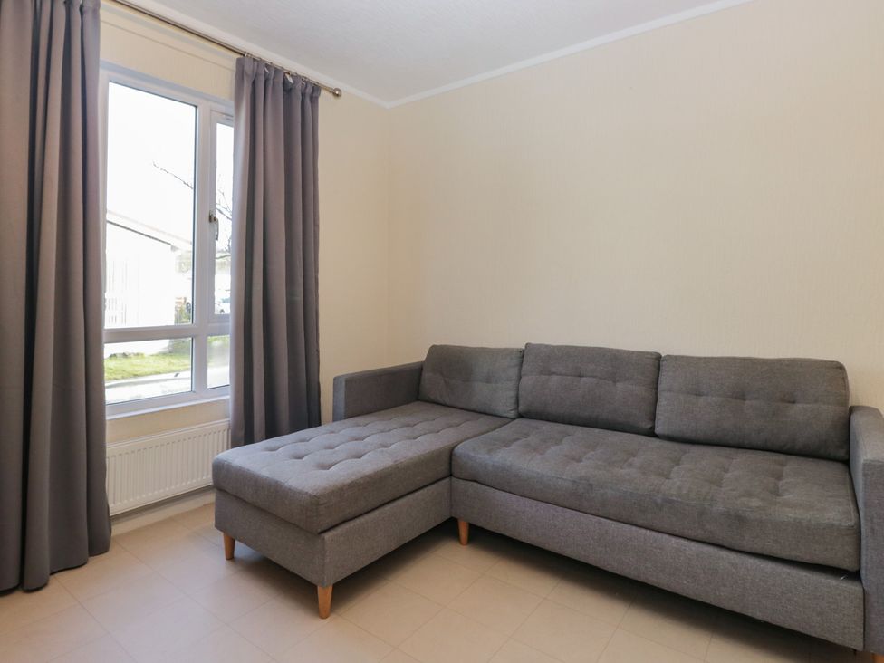 A living room with a sofa and window at Beechtree Timber Lodge 69B in Denny