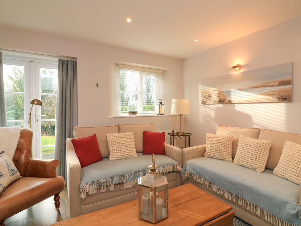 A living room with sofas and a coffee table at Blackstone Cottage in Salcombe