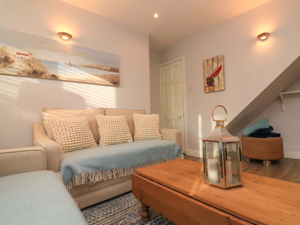 A living room with a sofa and coffee table at Blackstone Cottage in Salcombe
