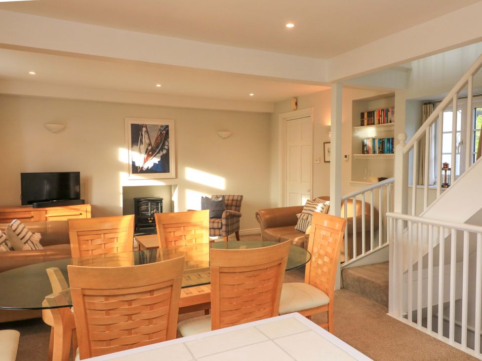 A living room with a dining table and sofa at Blackstone Cottage in Salcombe