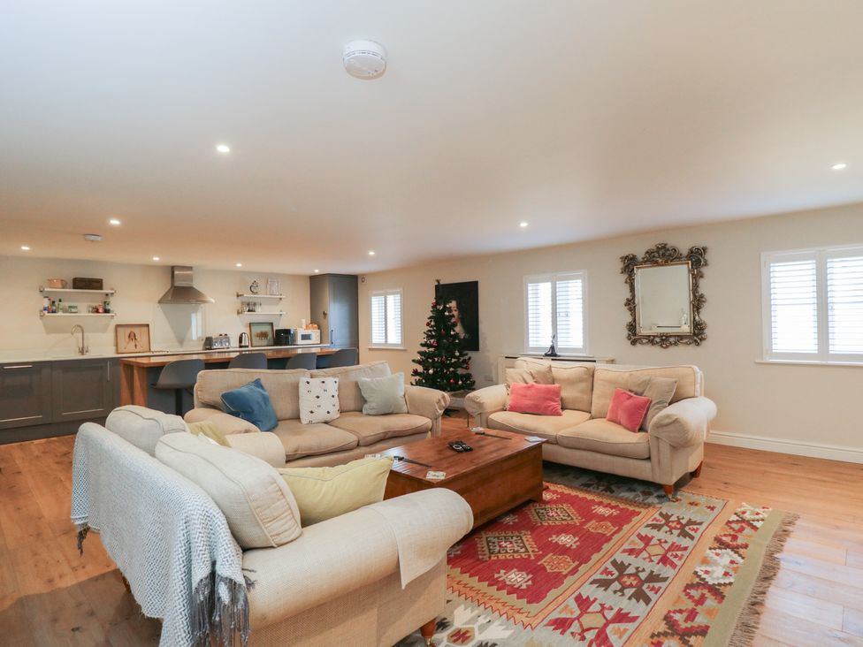 A living room with a sofa and coffee table at Flat 6