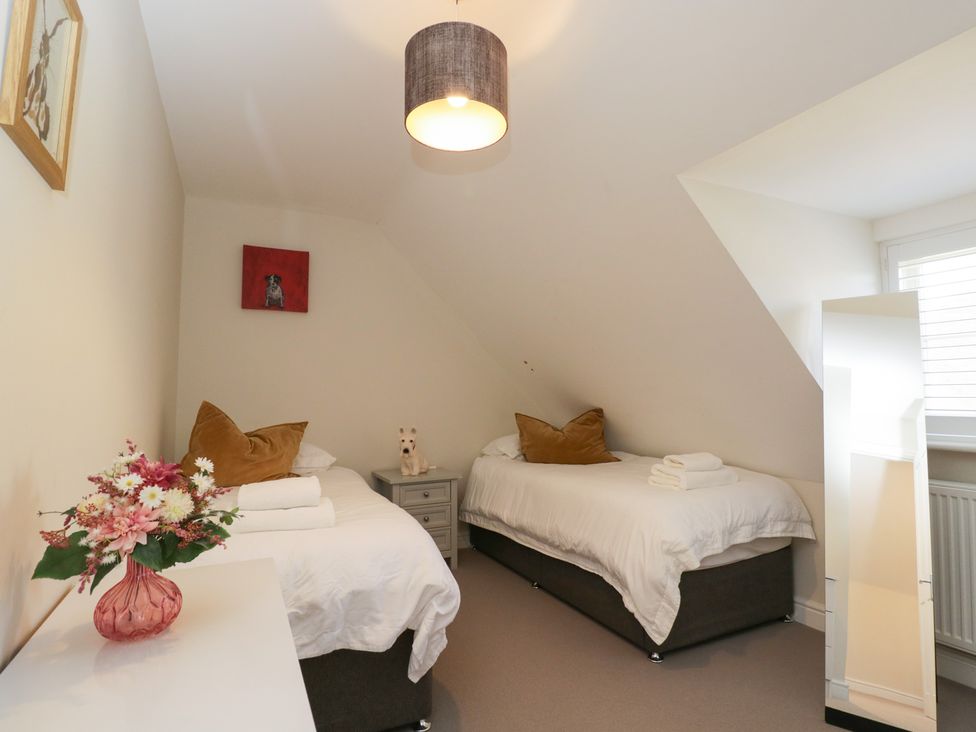 A bedroom with two single beds and a flower vase at Flat 6 in 